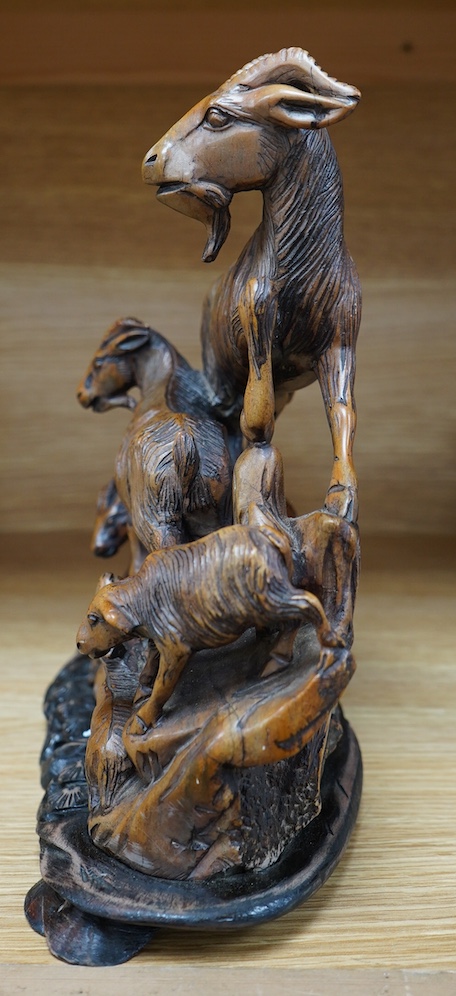 A Chinese carved soapstone figure group of goats on hardwood base, 24cm. Condition - fair to good